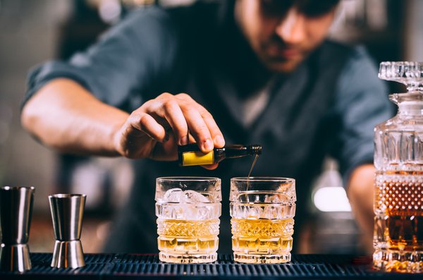 Bartender pouring bitters